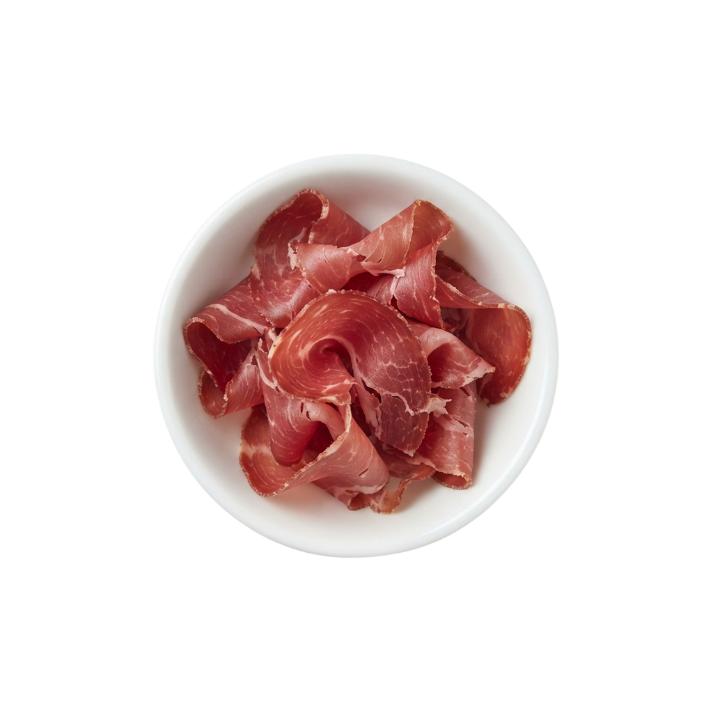 A white plate holding thin slices of raw pink pork belly meat