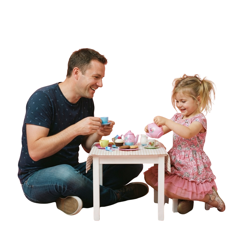 An adult and a young child smiling while using a miniature tea set at a small table