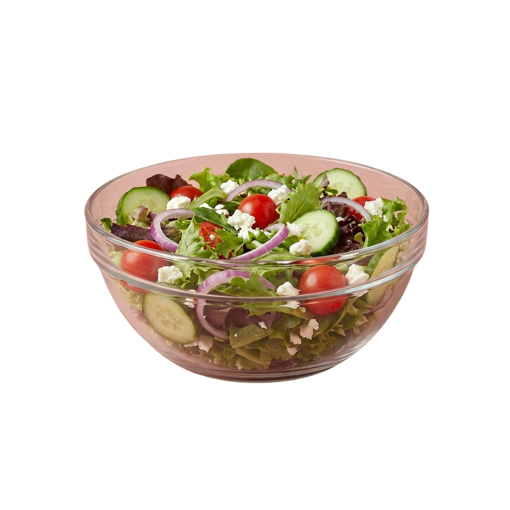 A clear bowl filled with a fresh salad containing mixed greens, cherry tomatoes, cucumber slices, red onions, and crumbled cheese