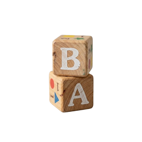Two wooden blocks stacked to spell BA with colorful symbols on the sides