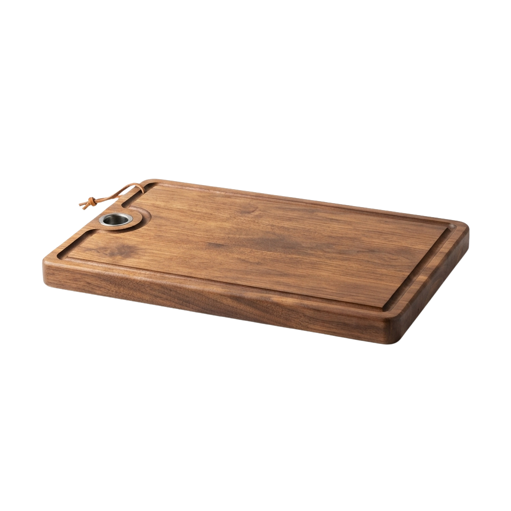 A rectangular wooden cutting board with a handle and juice groove on one of the short ends