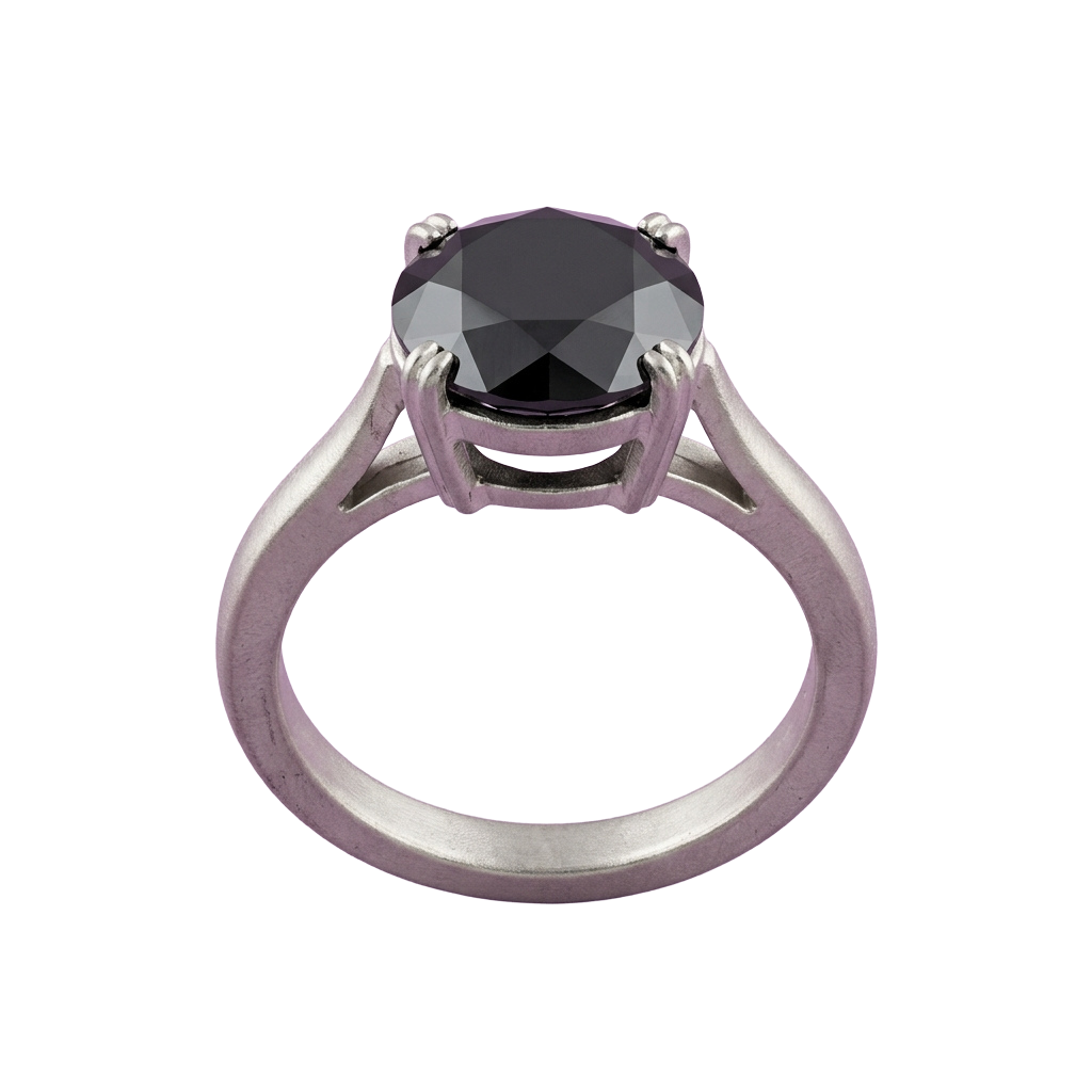 A rose gold ring with an oval-shaped black gemstone set in a prong setting, featuring intricate metalwork around the stone.