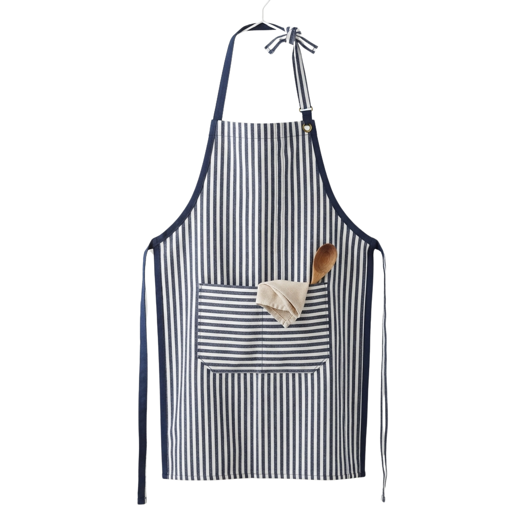 A striped blue and white apron hanging on a hook with a wooden spoon and cloth in the pocket