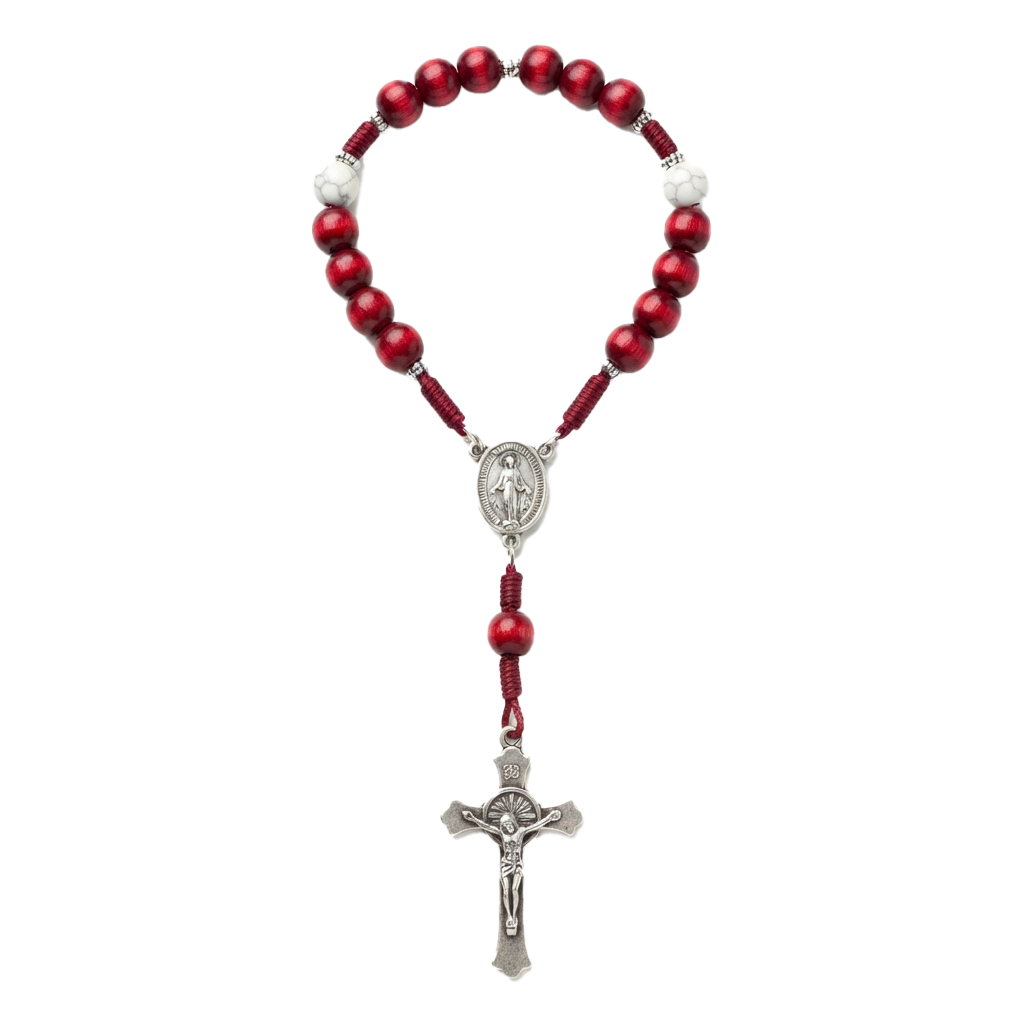 A red beaded rosary with a silver cross and medal pendant hanging from it
