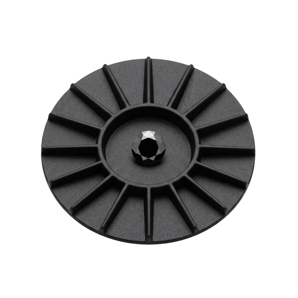 A black circular vent or diffuser with a central hole and evenly spaced ridges around the edge