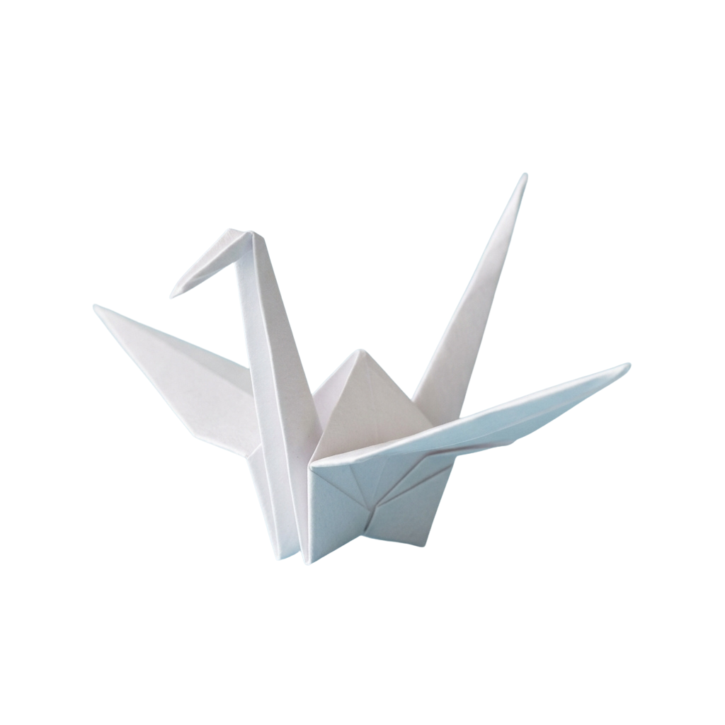 White origami paper crane with wings spread against a black background
