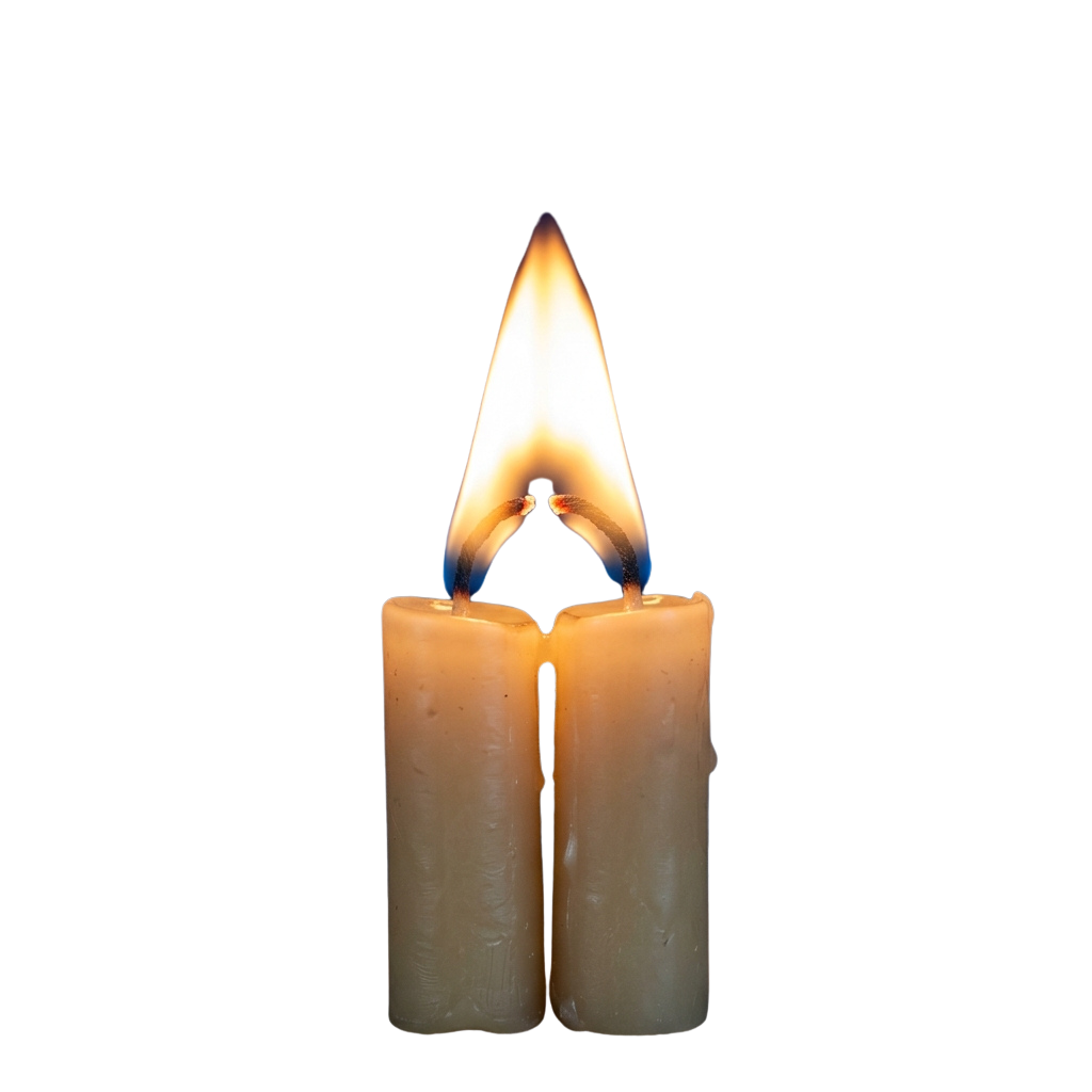 Two lit candles with bright yellow and blue flames burning in the dark