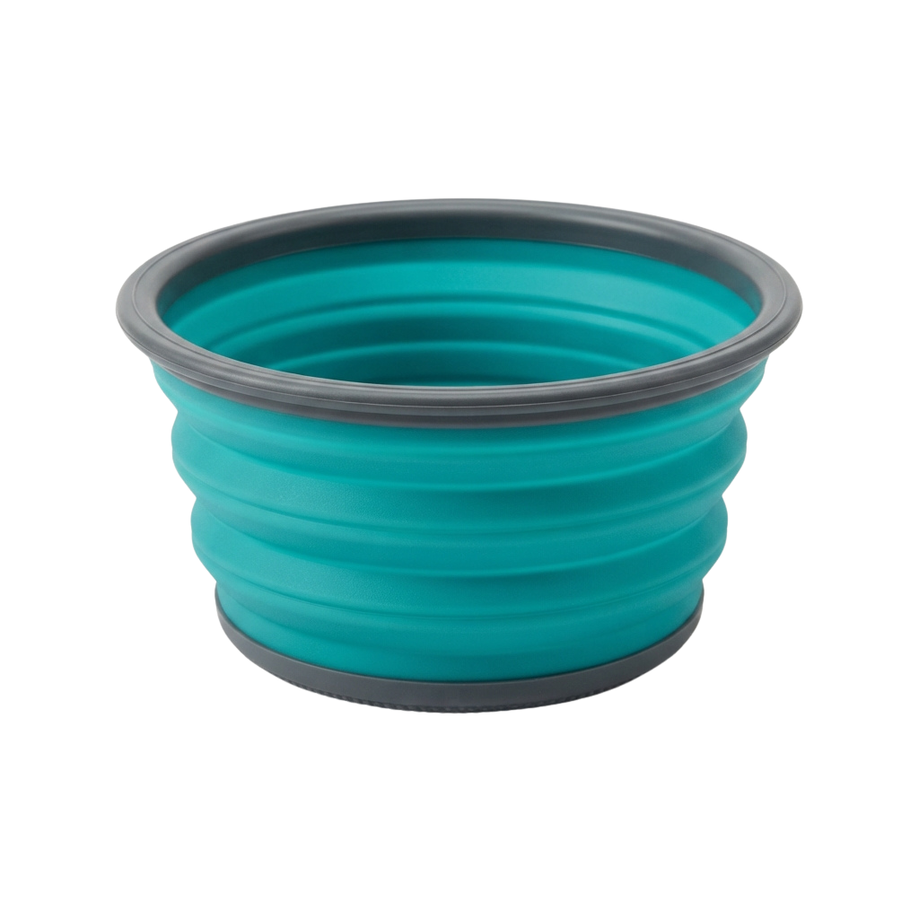 A turquoise silicone container with a wide rim and ridged texture, shown empty against a black background