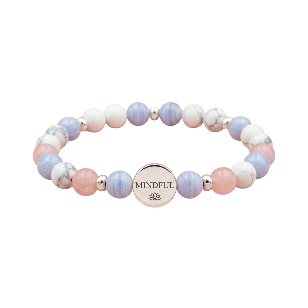 A bracelet with pastel blue and pink beads and a silver mindful charm featuring a lotus flower
