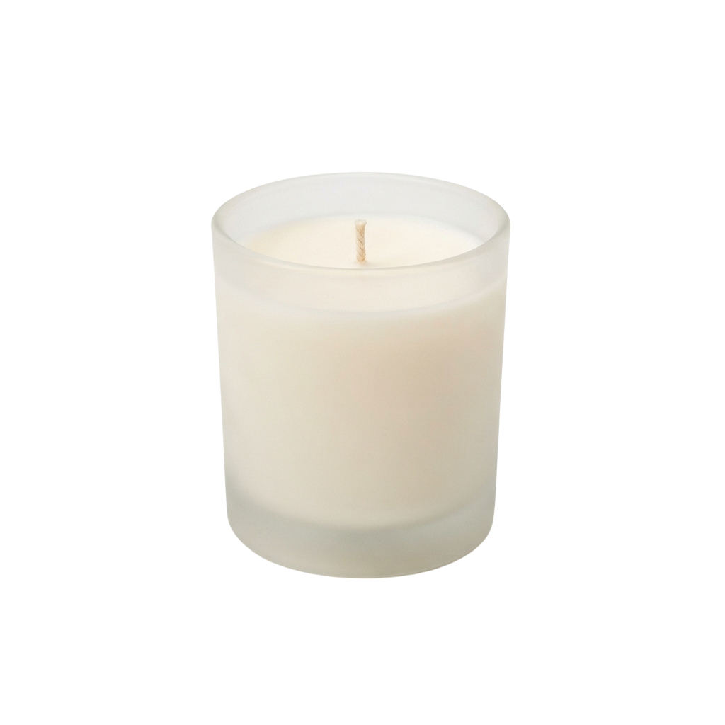 A lit white candle inside a clear cylindrical container with a wick burning softly