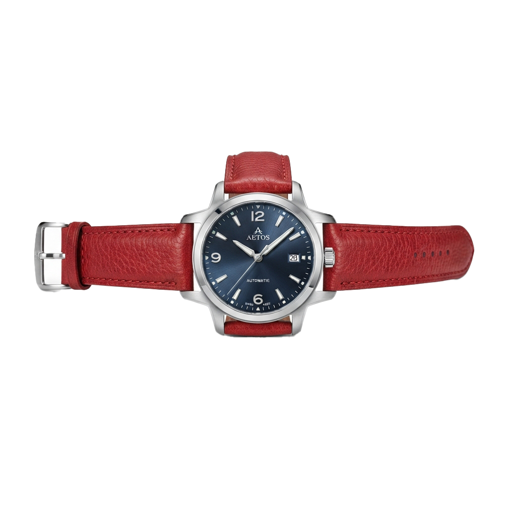 Automatic wristwatch with a red leather strap and silver metal case on a black background