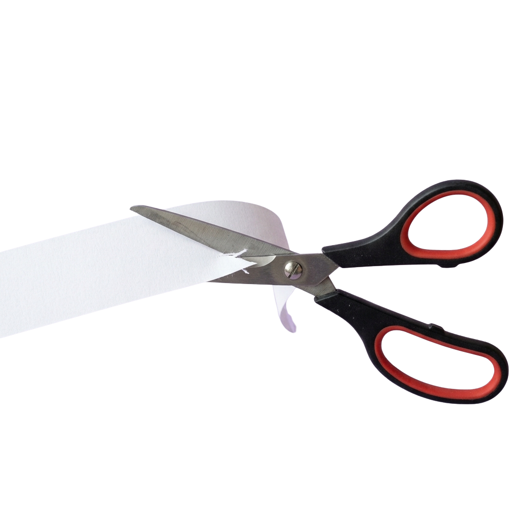 Black-handled scissors cutting a white sheet of paper against a black background