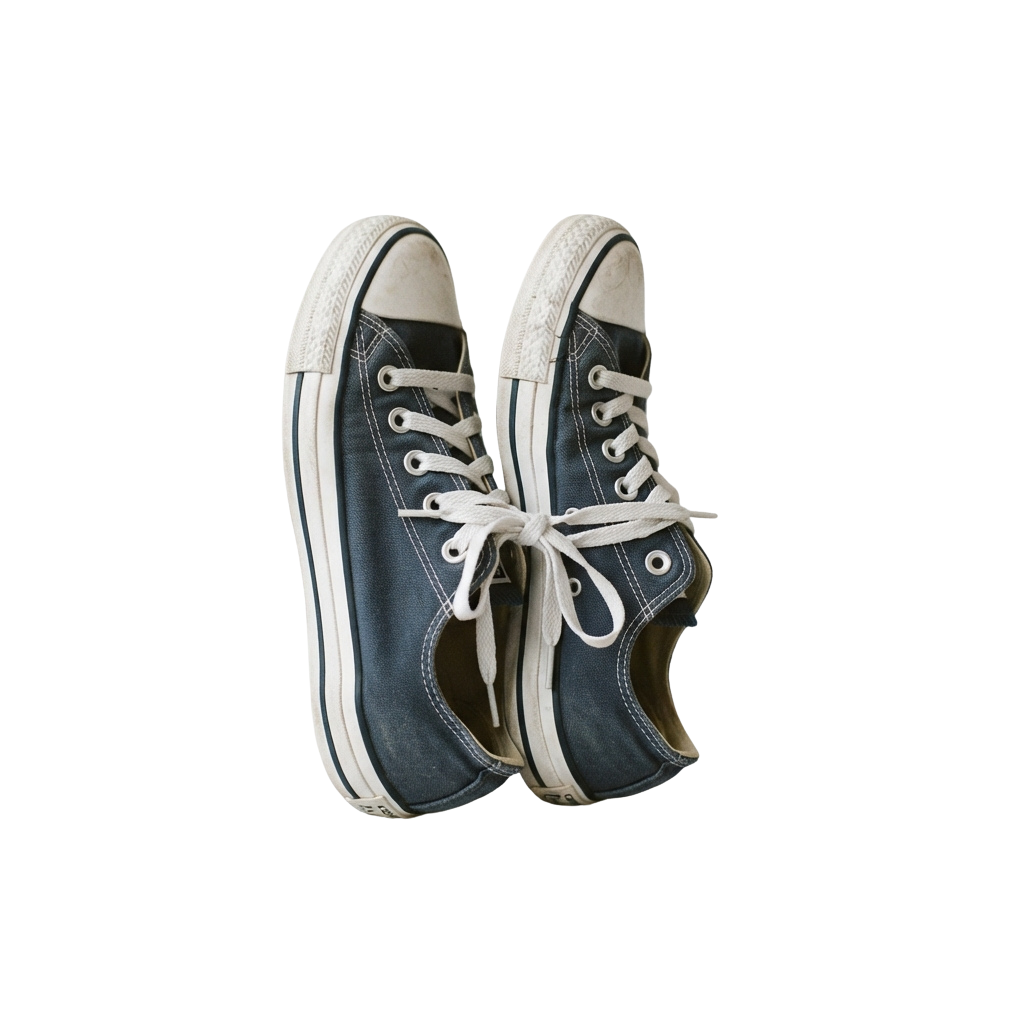 A pair of blue canvas high-top sneakers with white laces and soles against a black background