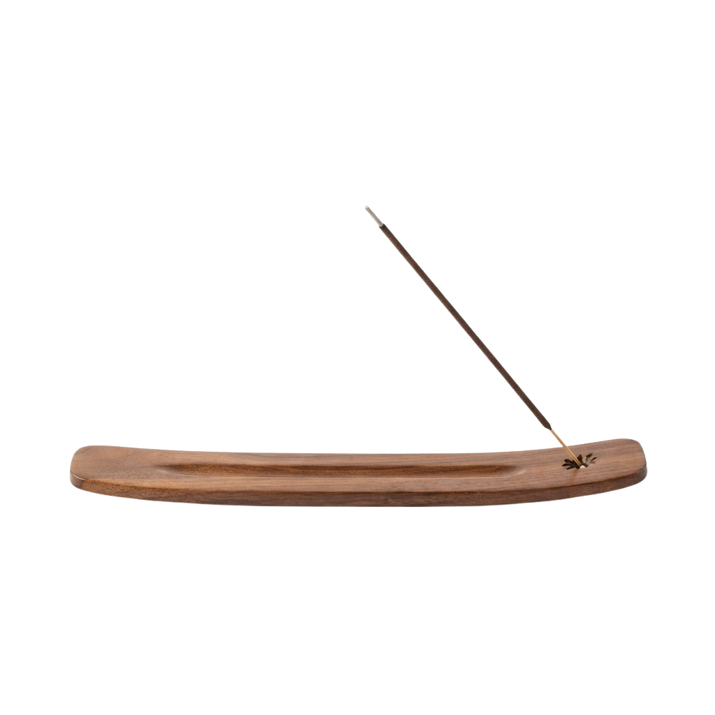 A wooden incense boat holder with a lit incense stick positioned on the right side