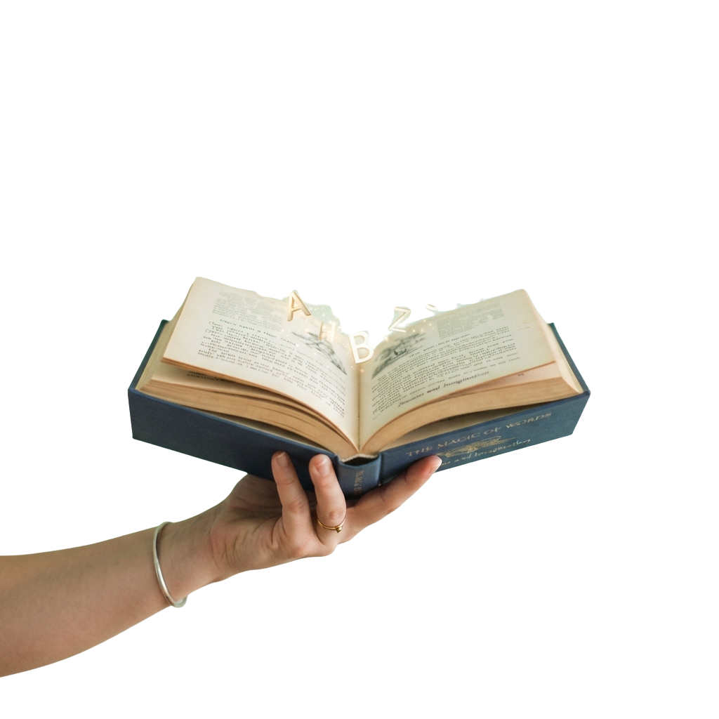 A hand holding an open book displaying a whimsical illustration on the pages.
