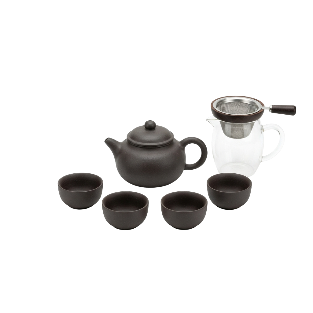 A dark ceramic teapot with lid, handle, and four matching cups alongside a metal tea strainer pitcher