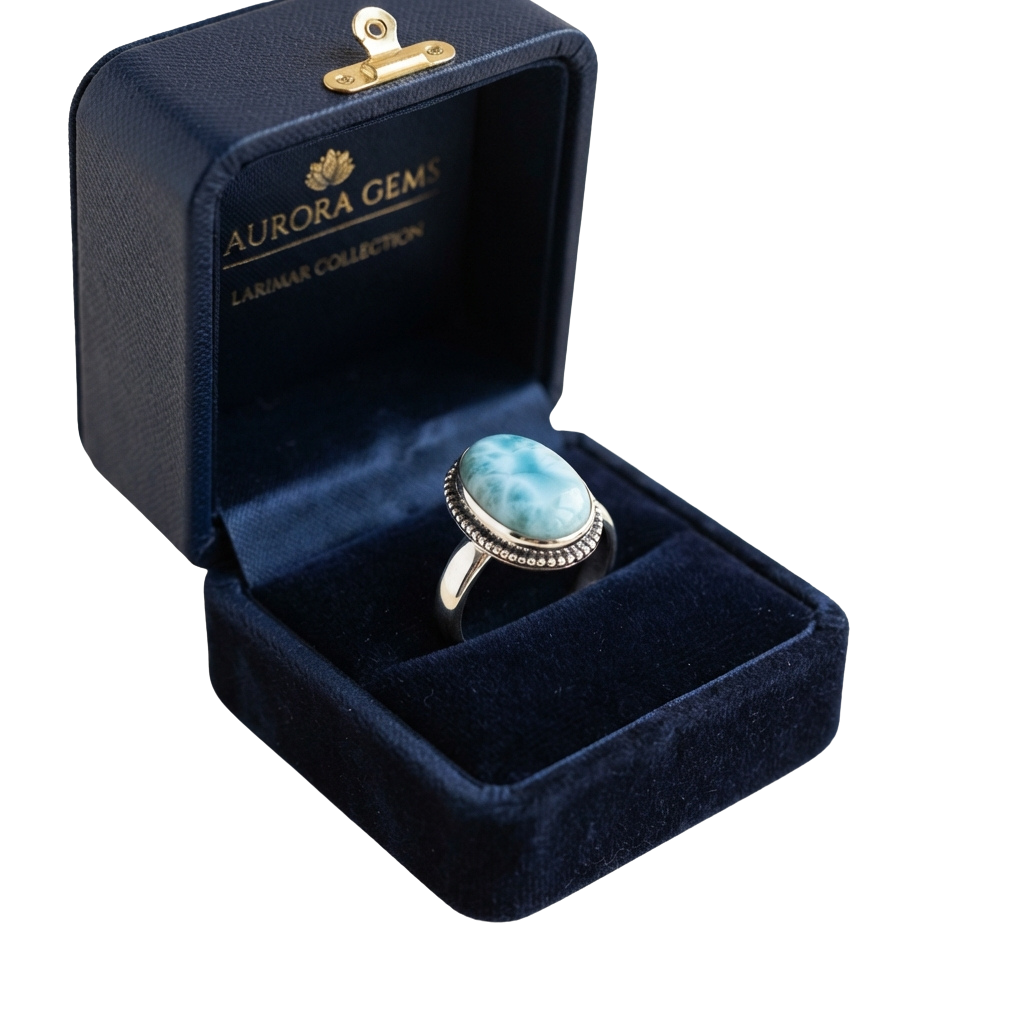 A larimar ring in a gold setting displayed in a velvet jewelry box with brand label