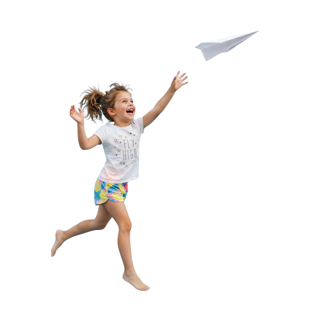 A young child mid-jump with arms raised, flying a white paper airplane.