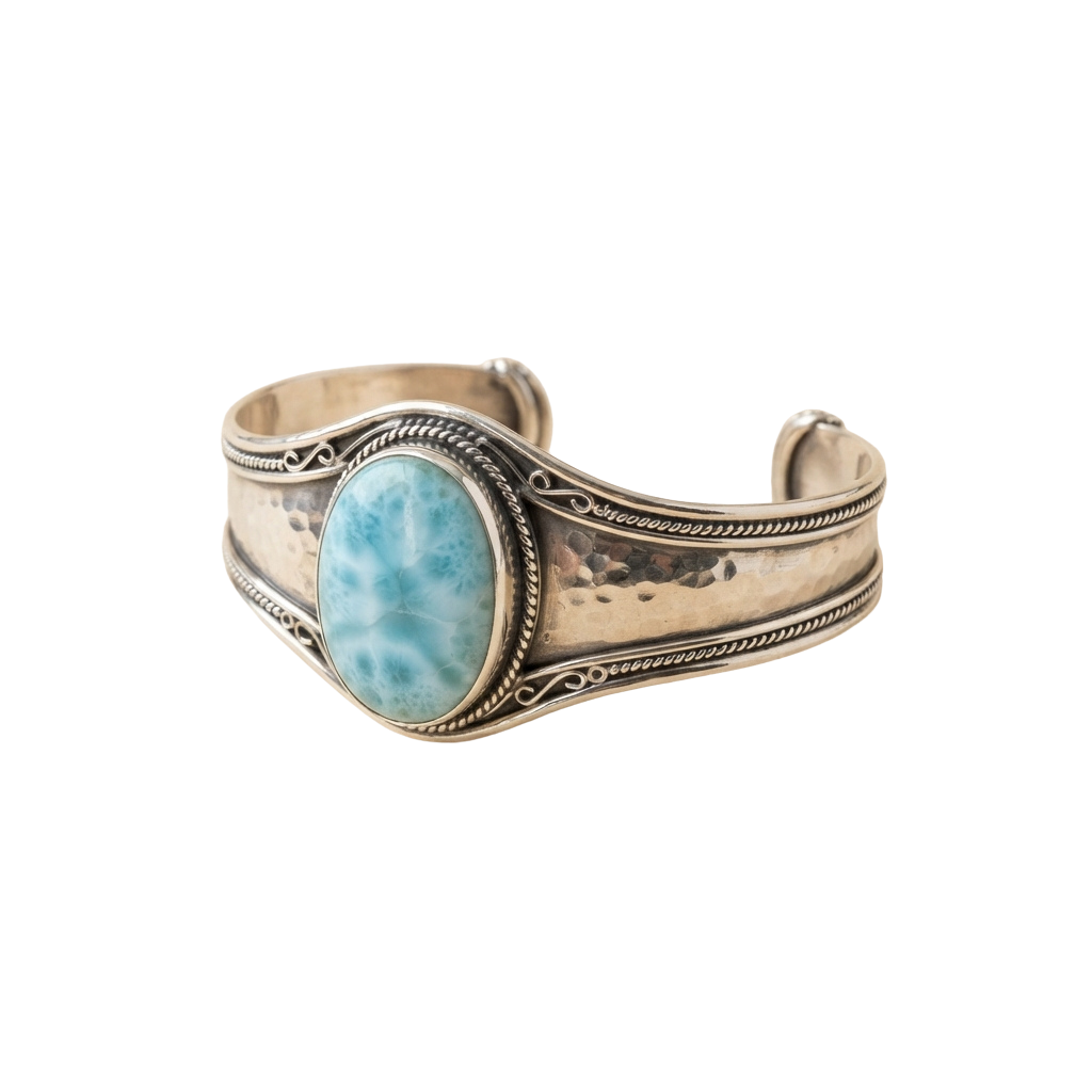 A cuff bracelet featuring a large oval turquoise stone centered on a textured metal band with detailed engravings