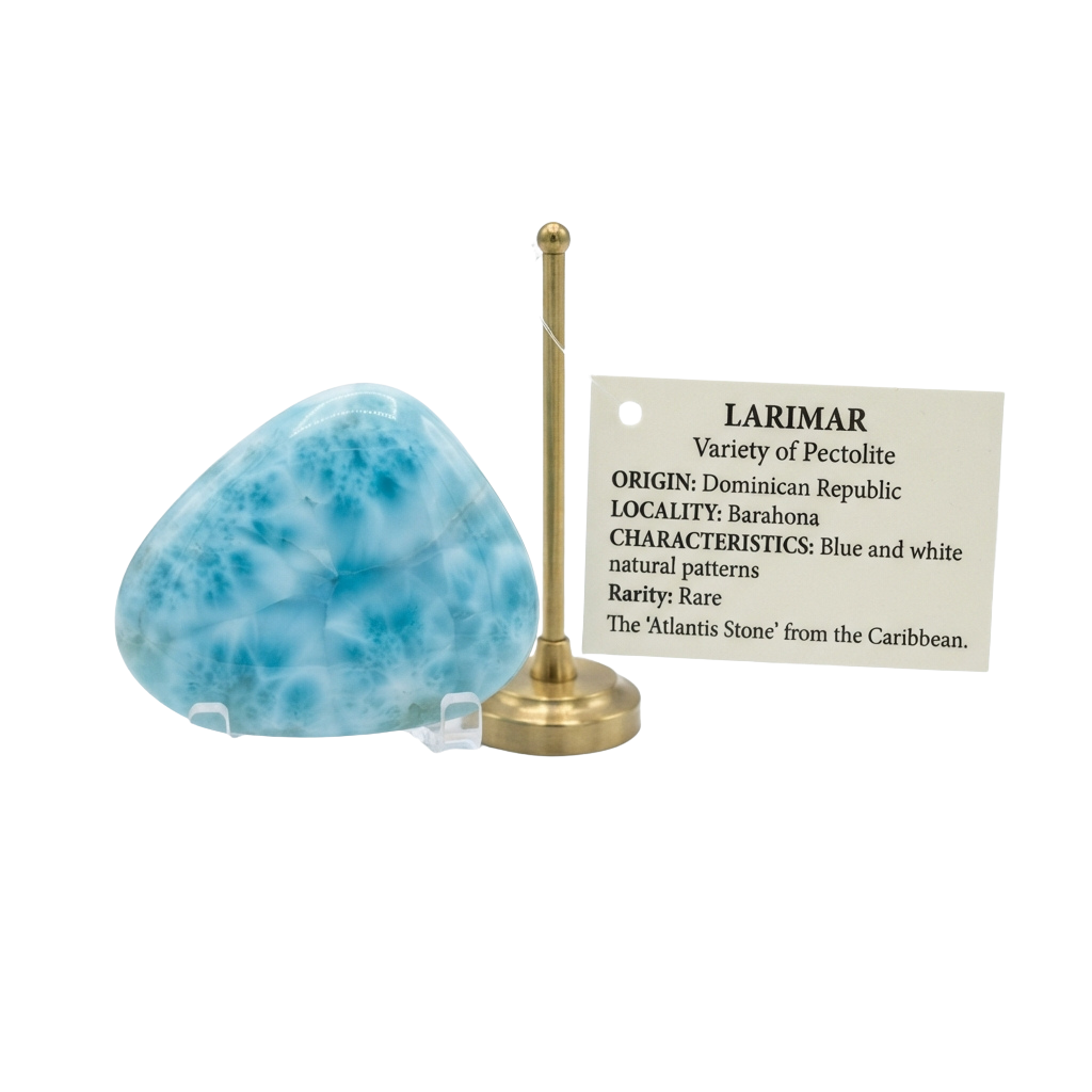 A blue larimar stone on a brass stand with a label displaying its characteristics and origin