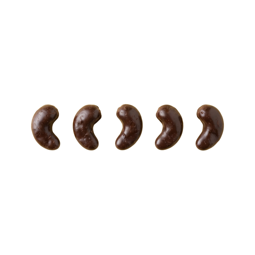Five brown chocolate-covered kidney beans on a dark background