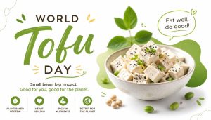 A bowl of tofu cubes with herbs and seeds, surrounded by soybeans and leaves