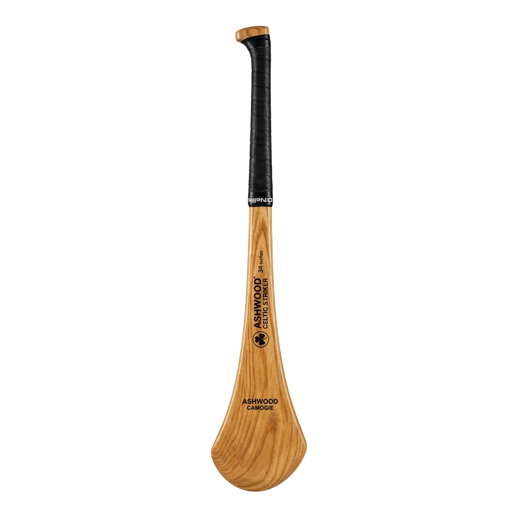 A wooden hurling stick with a black handle, labeled as Celtic Striker and Camogie, standing upright against a dark background