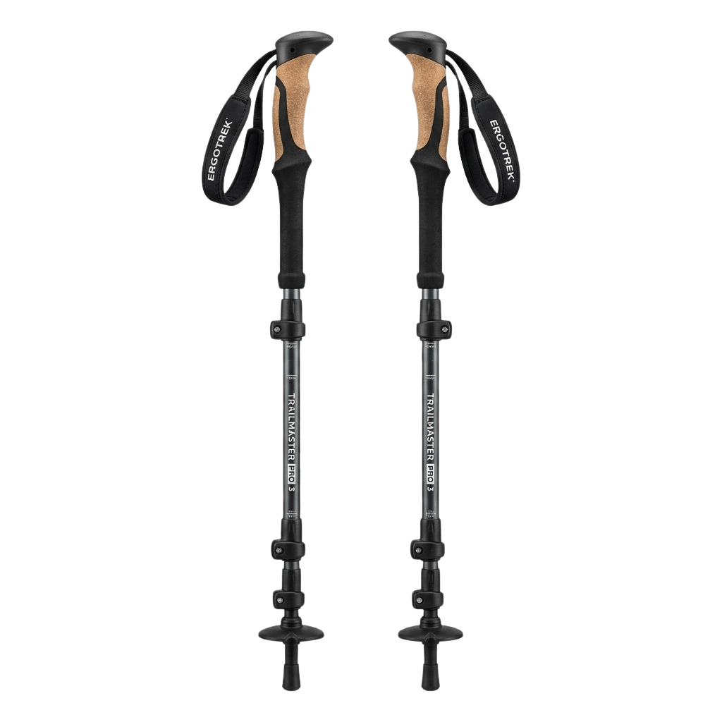 Two black adjustable trekking poles with tan foam grips and carbide tips against a dark background