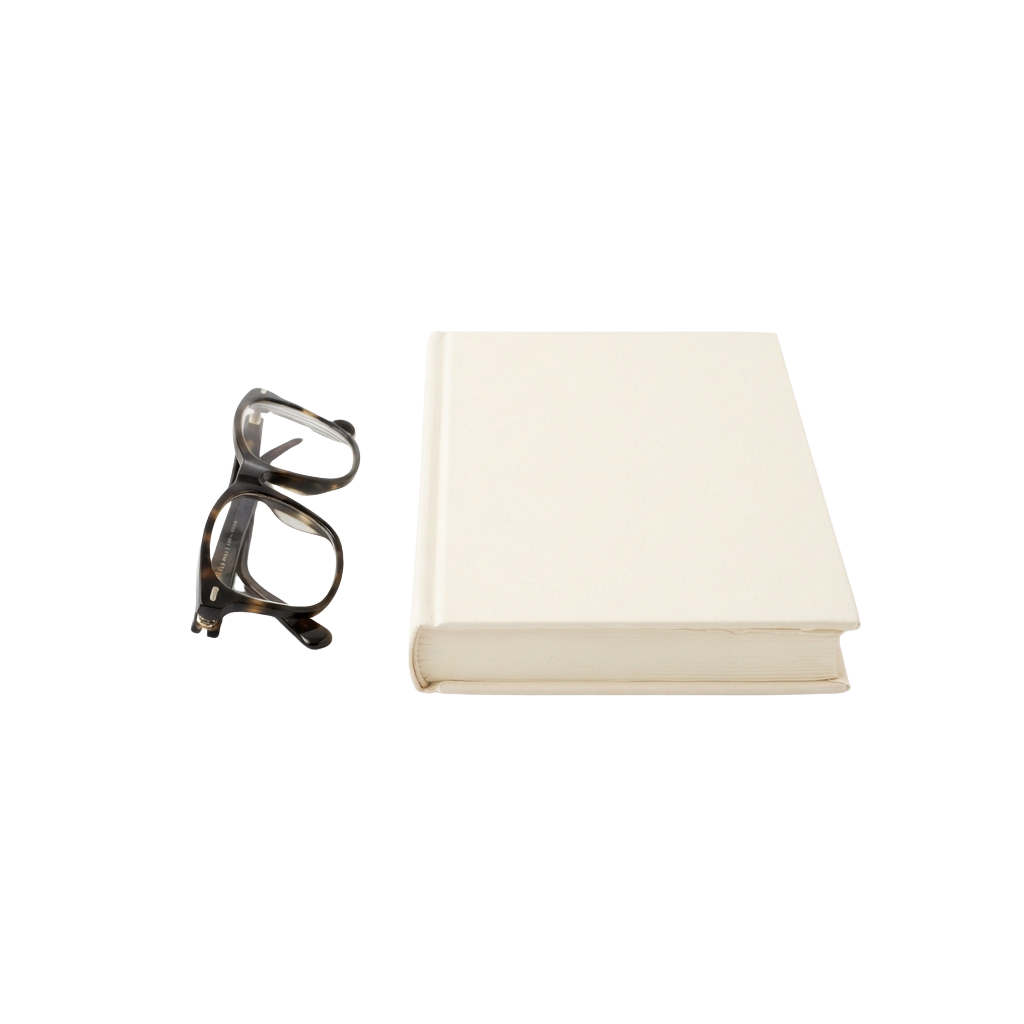 A pair of clear protective safety glasses next to a stack of white fabric or cloth.