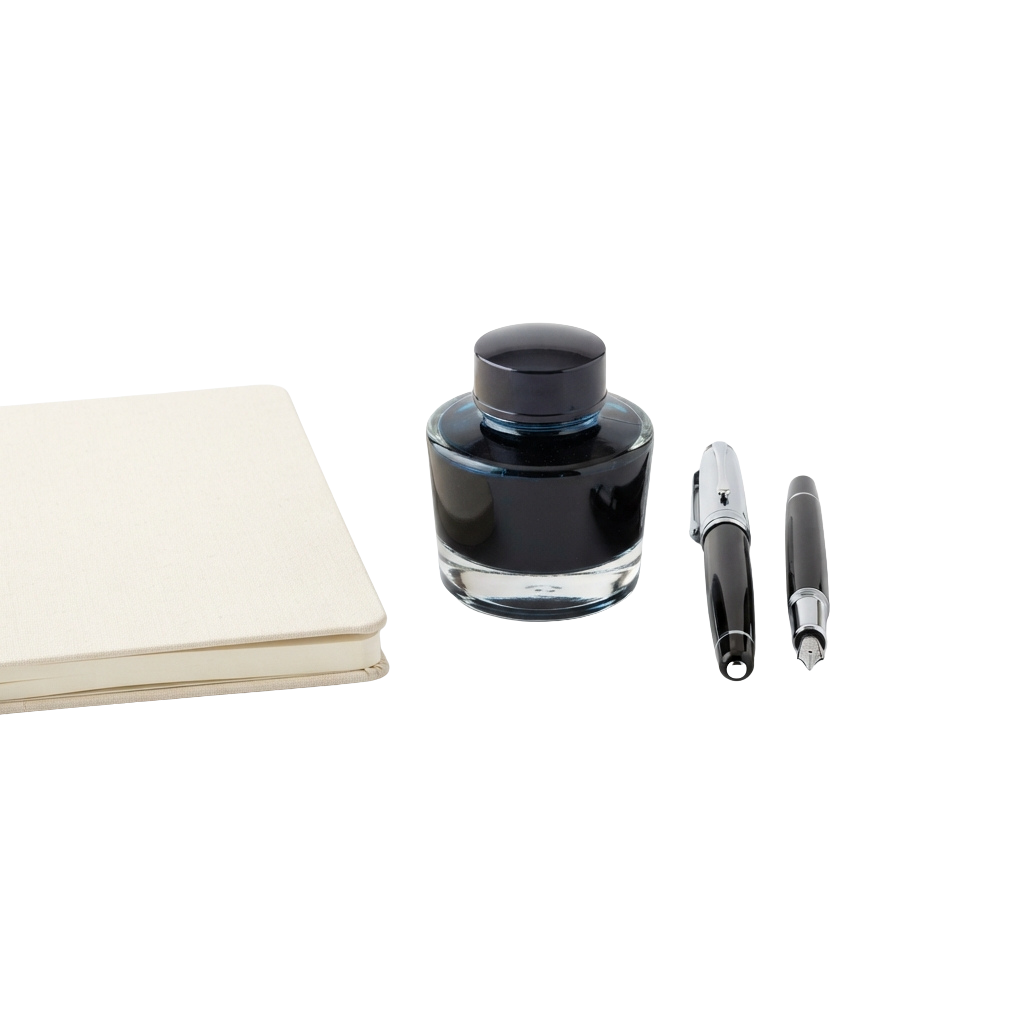 Calligraphy set including an ink bottle and two fountain pens on a white notebook