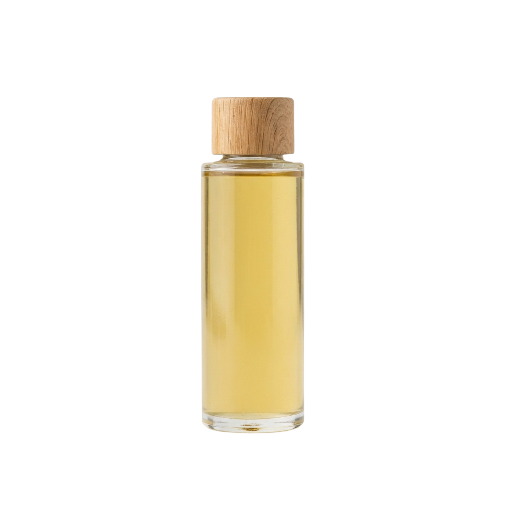 A clear glass bottle with a wooden cap containing a golden liquid, possibly perfume or essential oil