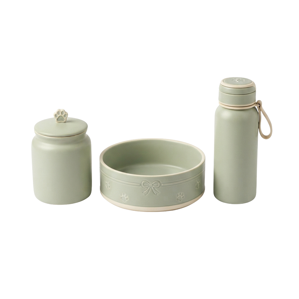 A light green ceramic pet food jar, shallow bowl with paw prints and bow design, and matching insulated water bottle