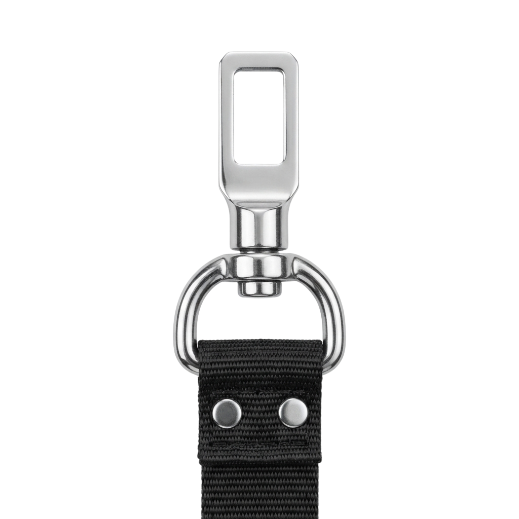 Close-up of a metallic belt buckle with a rectangular opening and a looped attachment, connected to a black fabric belt with two metal buttons.