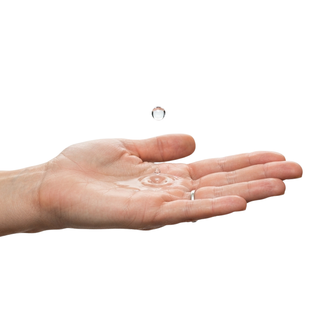 A hand catching a single water droplet mid-air in an open palm