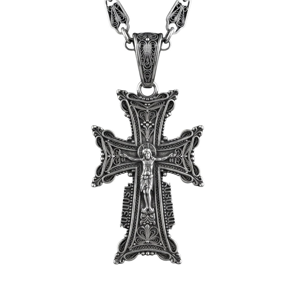 A detailed silver cross necklace featuring an engraved Jesus figurine on the cross.