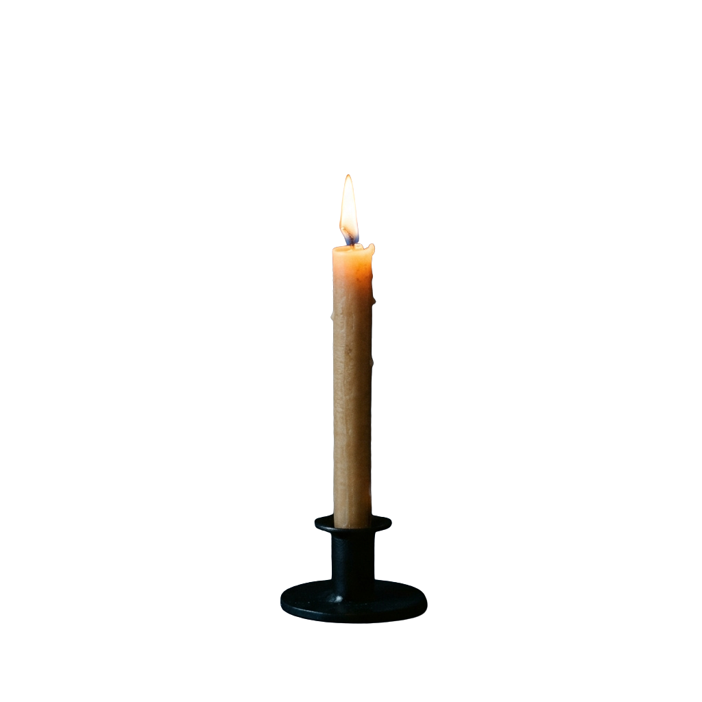 A single candle with a lit wick placed on a dark holder against a black background