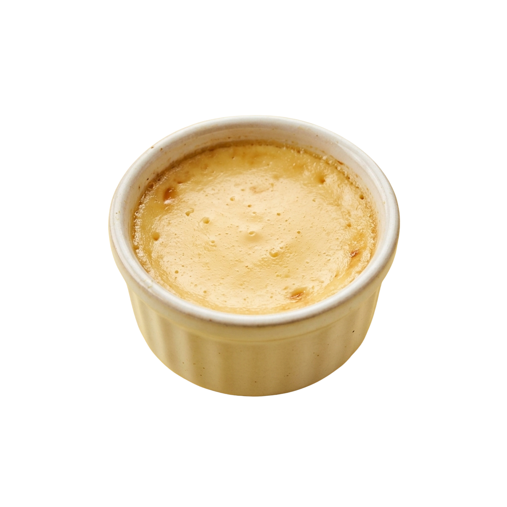 A small white ceramic cup filled with frothy iced coffee beverage.