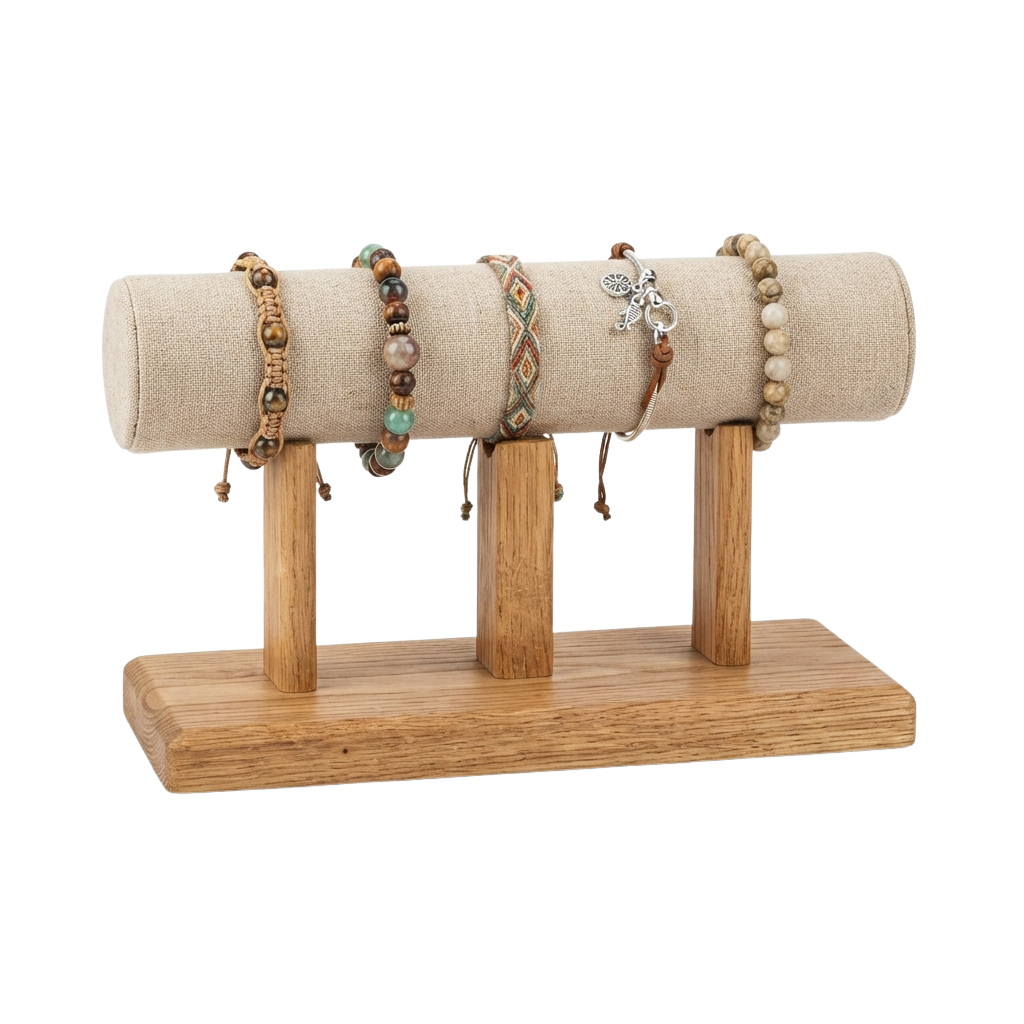 A wooden jewelry stand holding three handcrafted beaded bracelets on a fabric roller