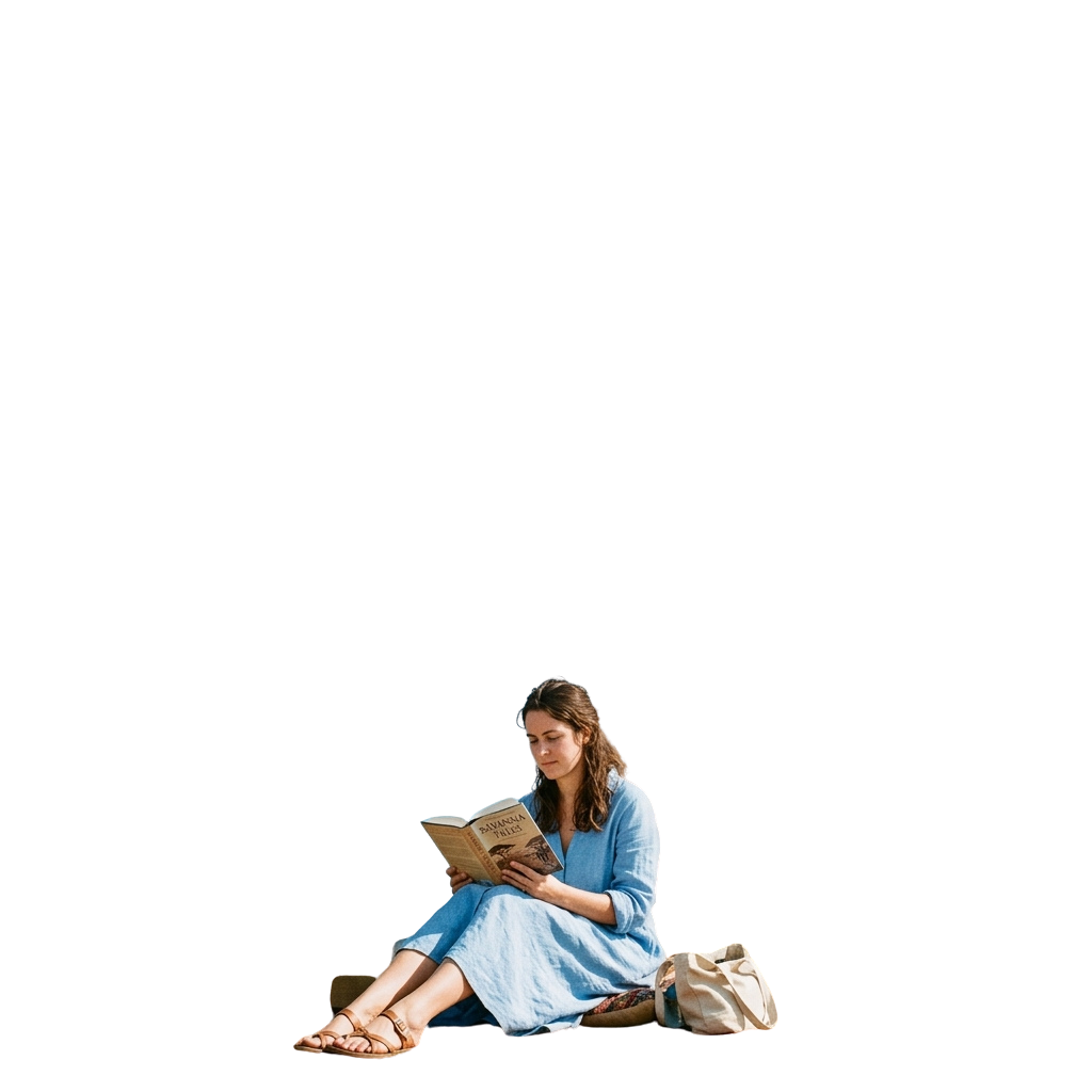 A woman sitting outdoors reading a book while wearing a light blue dress and sandals