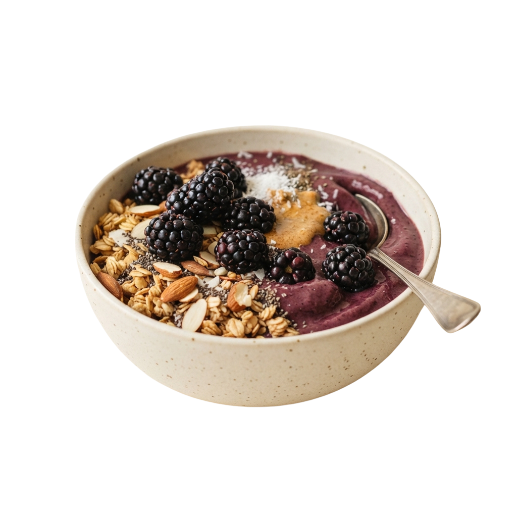 Bowl of blackberry overnight oats topped with granola, nuts, and seeds on a white ceramic dish