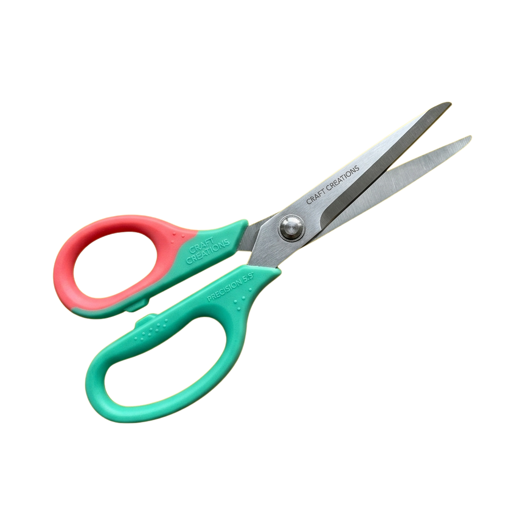 Pair of scissors with turquoise and pink ergonomic handles and sharp metal blades