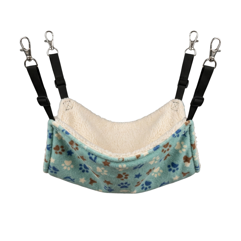 A cozy pet hammock with a plush inner lining and paw and star floral pattern fabric, suspended by straps with carabiners
