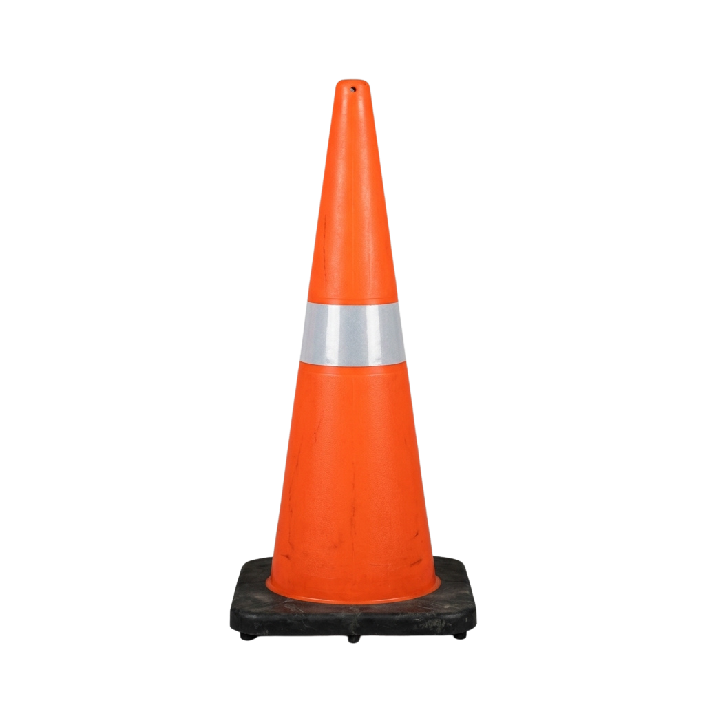 Orange traffic cone with reflective white stripe on black base against dark background
