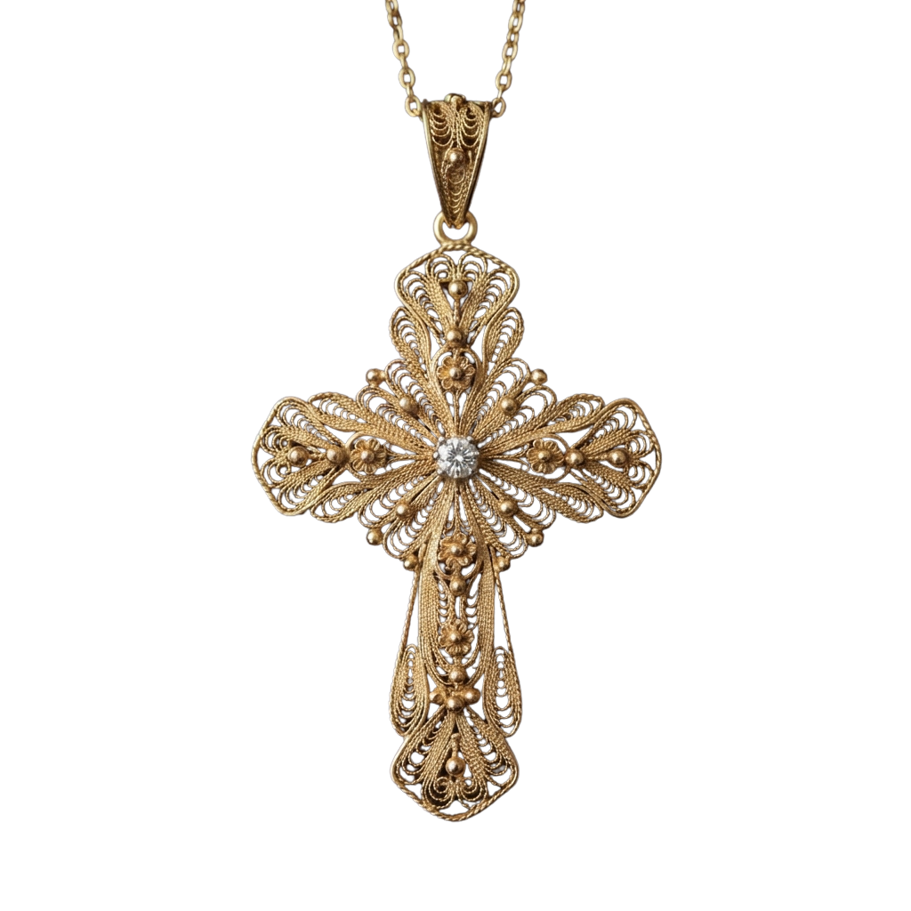 Gold filigree cross pendant necklace featuring intricate designs and a small diamond at the center