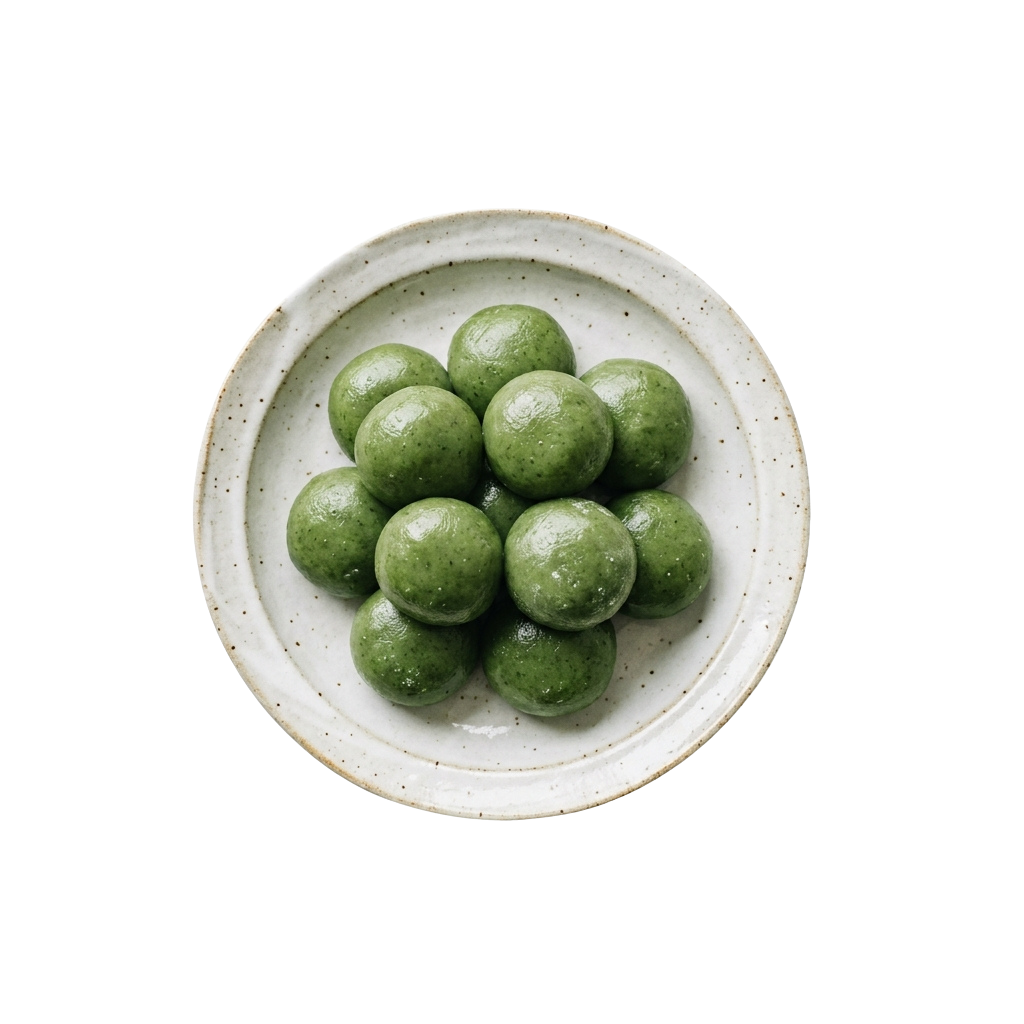 A white ceramic plate holding round green matcha mochi balls.