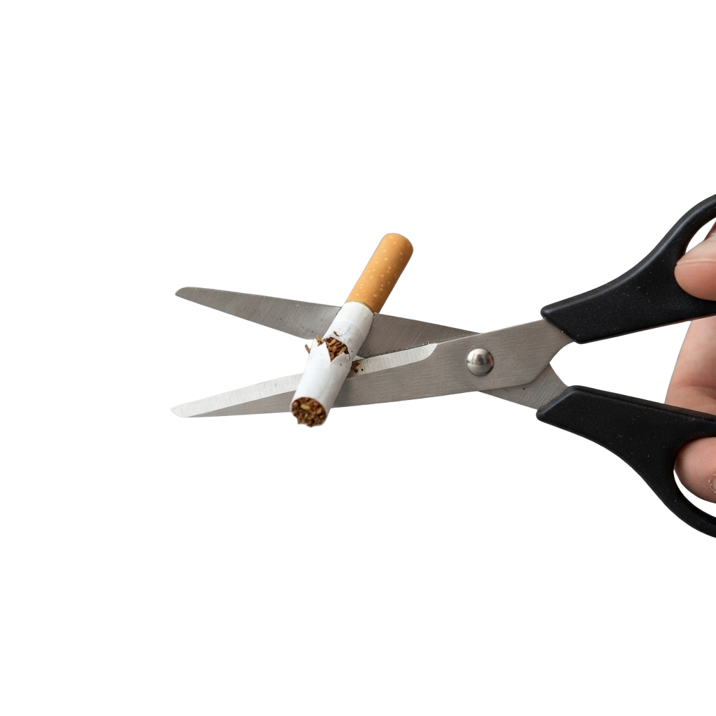 Pair of scissors cutting a cigarette in half against a black background
