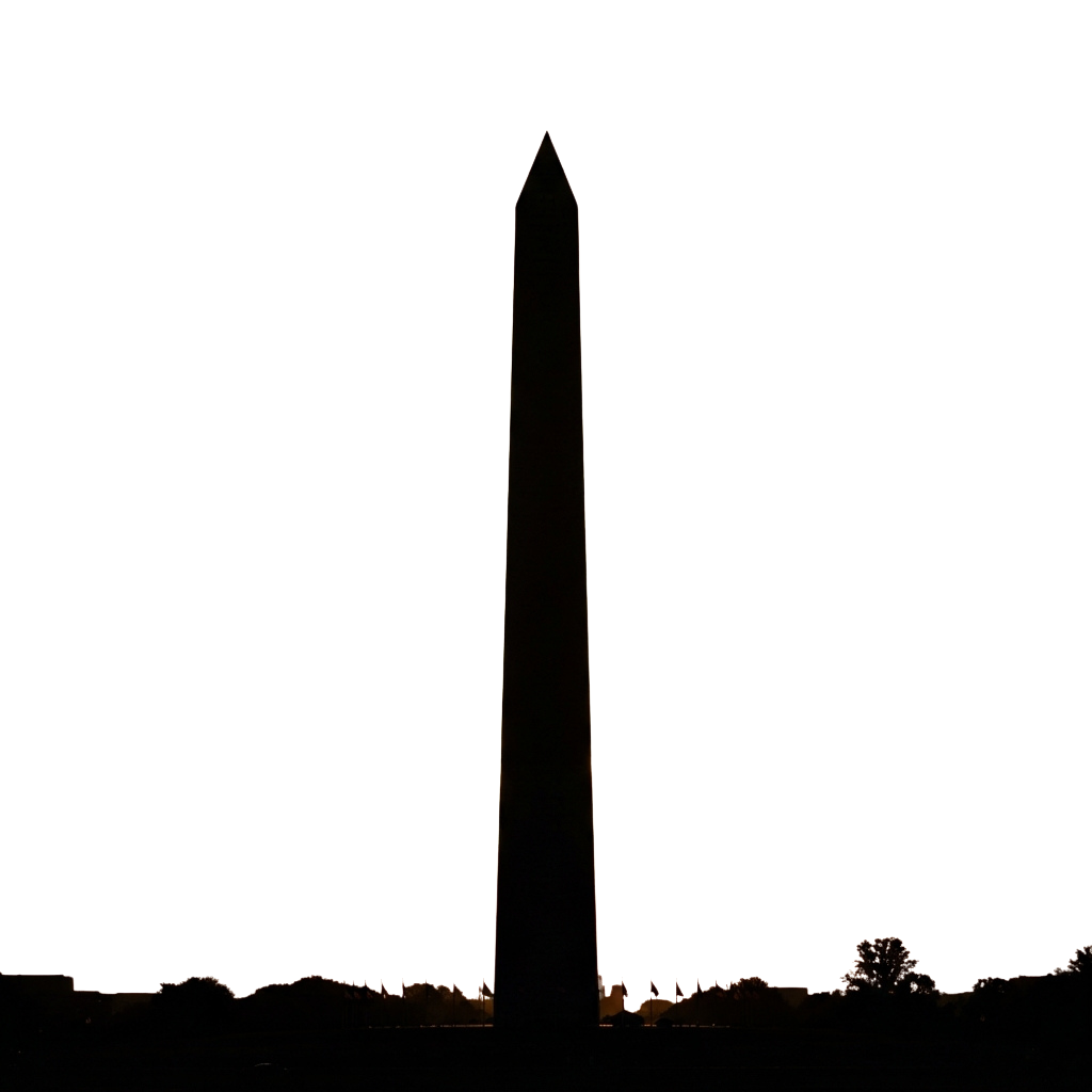 A tall, illuminated monument standing alone at night with a dark sky background.