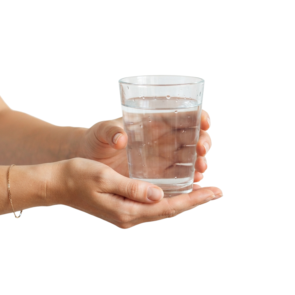 A person holding a clear plastic cup filled with water.