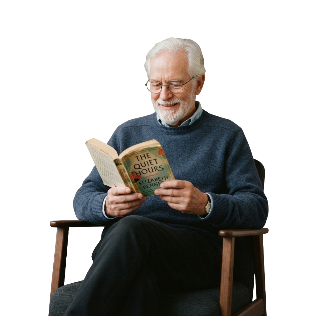 Smiling older man with glasses reading an open book in a cozy chair