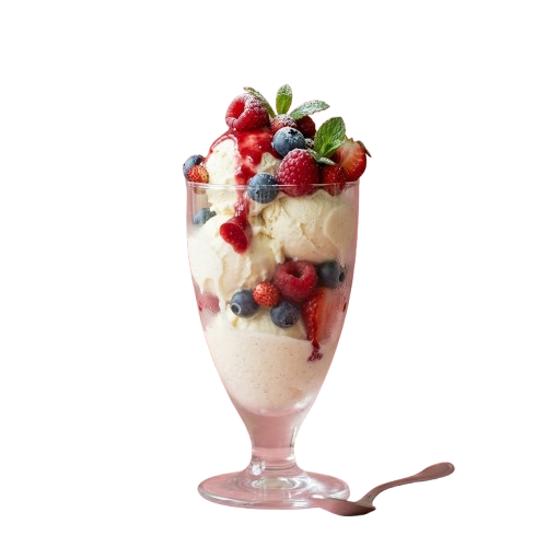 A glass dessert with creamy layers topped with fresh berries and mint leaves, placed on a black background with a pink spoon